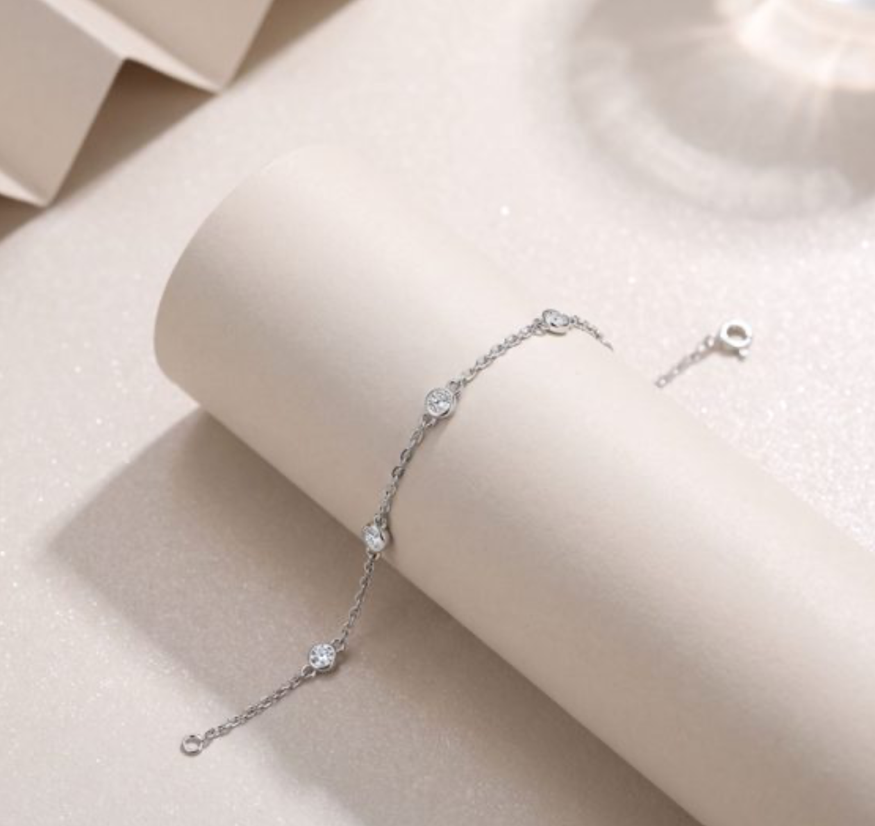 Pulseira em prata 925 com sete moissanites redondas em bezel, design geométrico espaçado. 16cm + extensor 5cm.