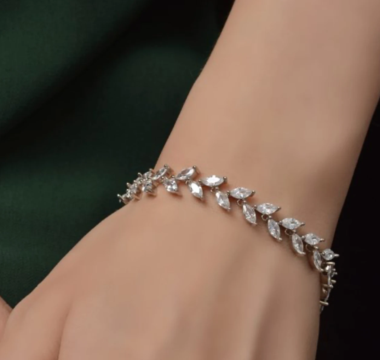 Silver marquise-cut zirconia vine link bracelet worn on the wrist