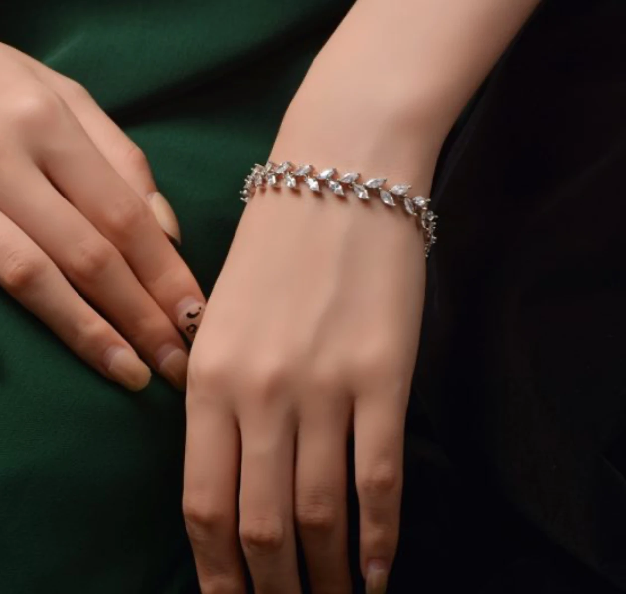 Silver marquise-cut zirconia vine link bracelet worn on the wrist